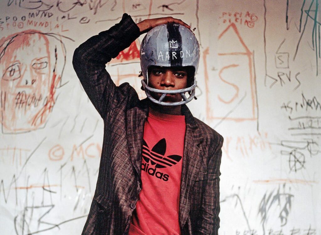 Edo Bertoglio. Jean-Michel Basquiat wearing an American football helmet, 1981. Detail. Photo: © Edo Bertoglio, courtesy of Maripol. Artwork: © The Estate of Jean-Michel Basquiat. Licensed by Artestar, New York