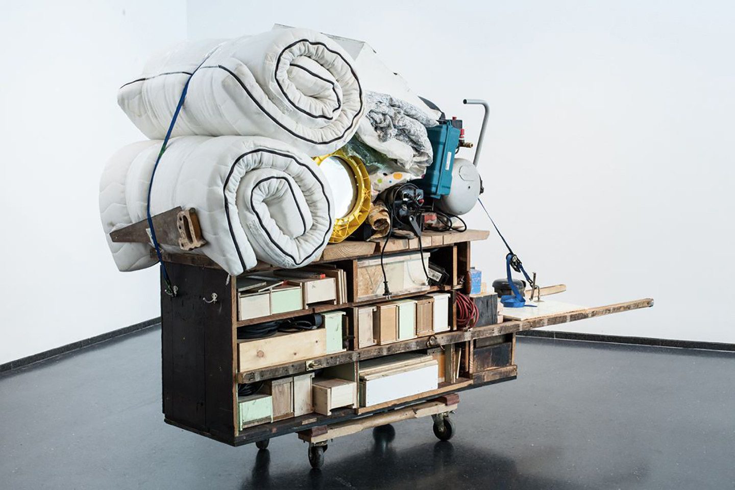 Theater Gates, Migration Rickshaw for Sleeping, Playing, and Building, 2013. Wood, fabric, metal, plastic, Huguenot House remnants, 68 x 104 x 46 inches. View of 13th Ballad, Museum of Contemporary Art, Chicago, 2013. © Theater Gates. Photo: Sara Pooley Photography. Courtesy of the artist.