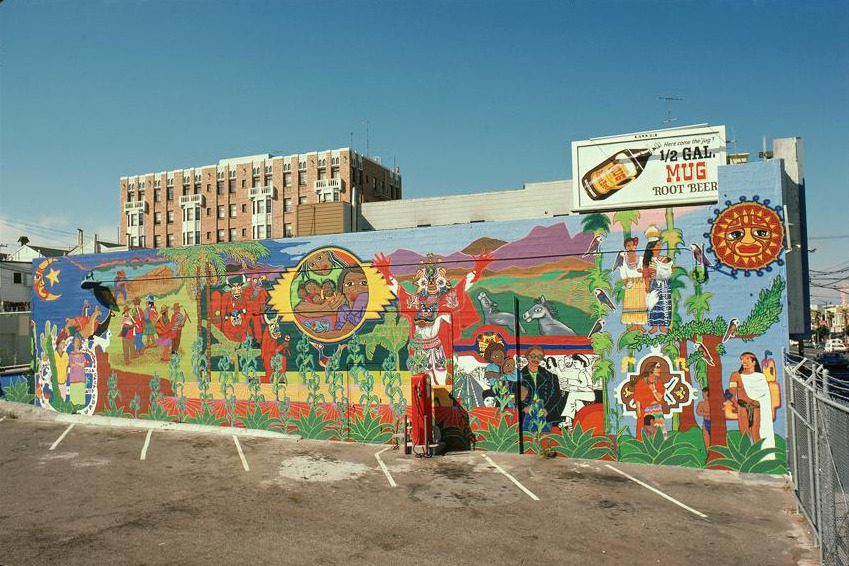 Mujeres Muralistas. Latinoamerica. 1974. Roy Anderson paints on concrete. 20’ x 76’. Mission St. bet. 25th & 26th St, San Francisco.