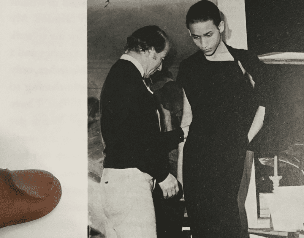 Jimmy Robert, 2018, research still, Charles James adjusting a black crepe gown on Juan Fernandez, photo by Bill Cunningham in Douglas Crimp, Before Pictures, 2016