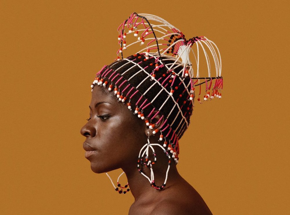 Kwame Brathwaite, Sikolo Brathwaite wearing a headpiece designed by Carolee Prince, African Jazz-Art Society & Studios (AJASS), Harlem, ca. 1968; from Kwame Brathwaite: Black Is Beautiful (Aperture, 2019)